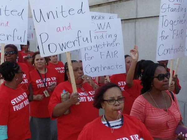 CWA members with signs saying "united and powerful"
